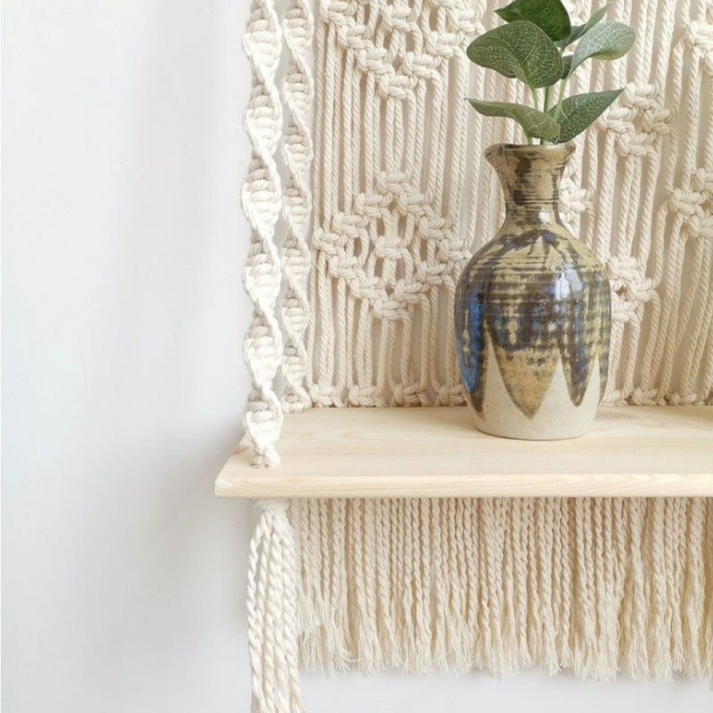 Macramé wall decoration with a shelf